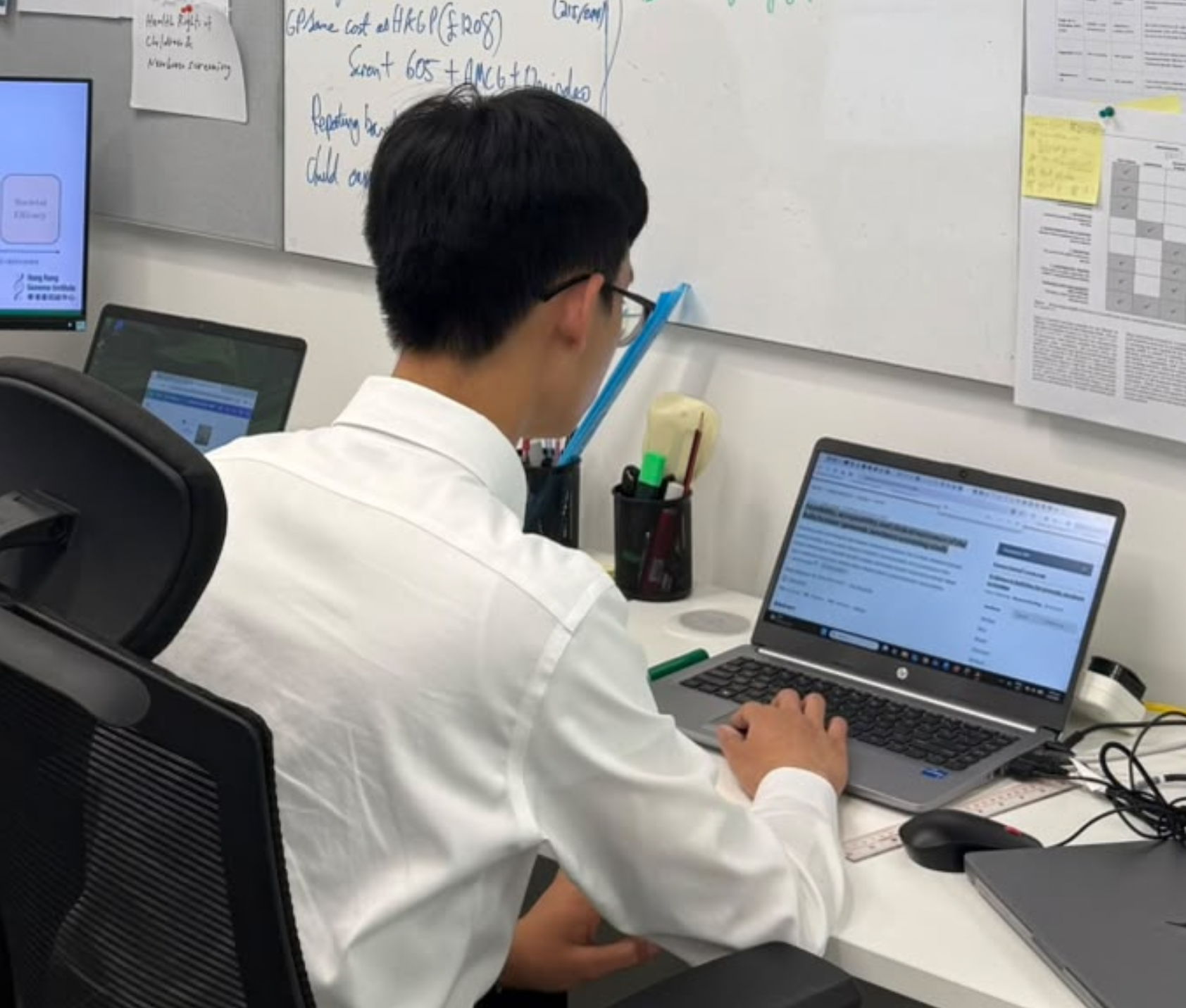 Student working on research at a laptop